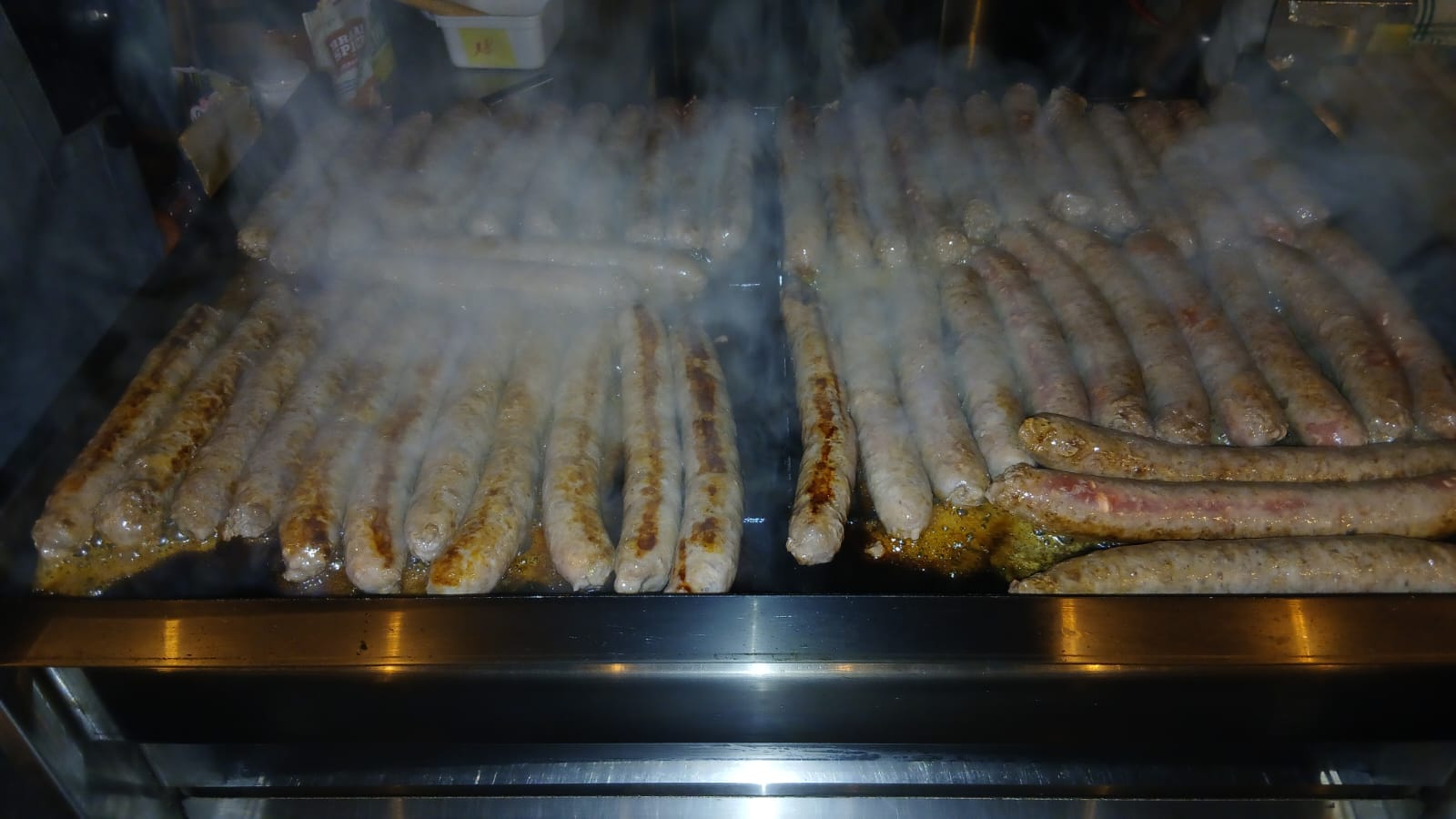 Rows of boerewors sizzling on the grill