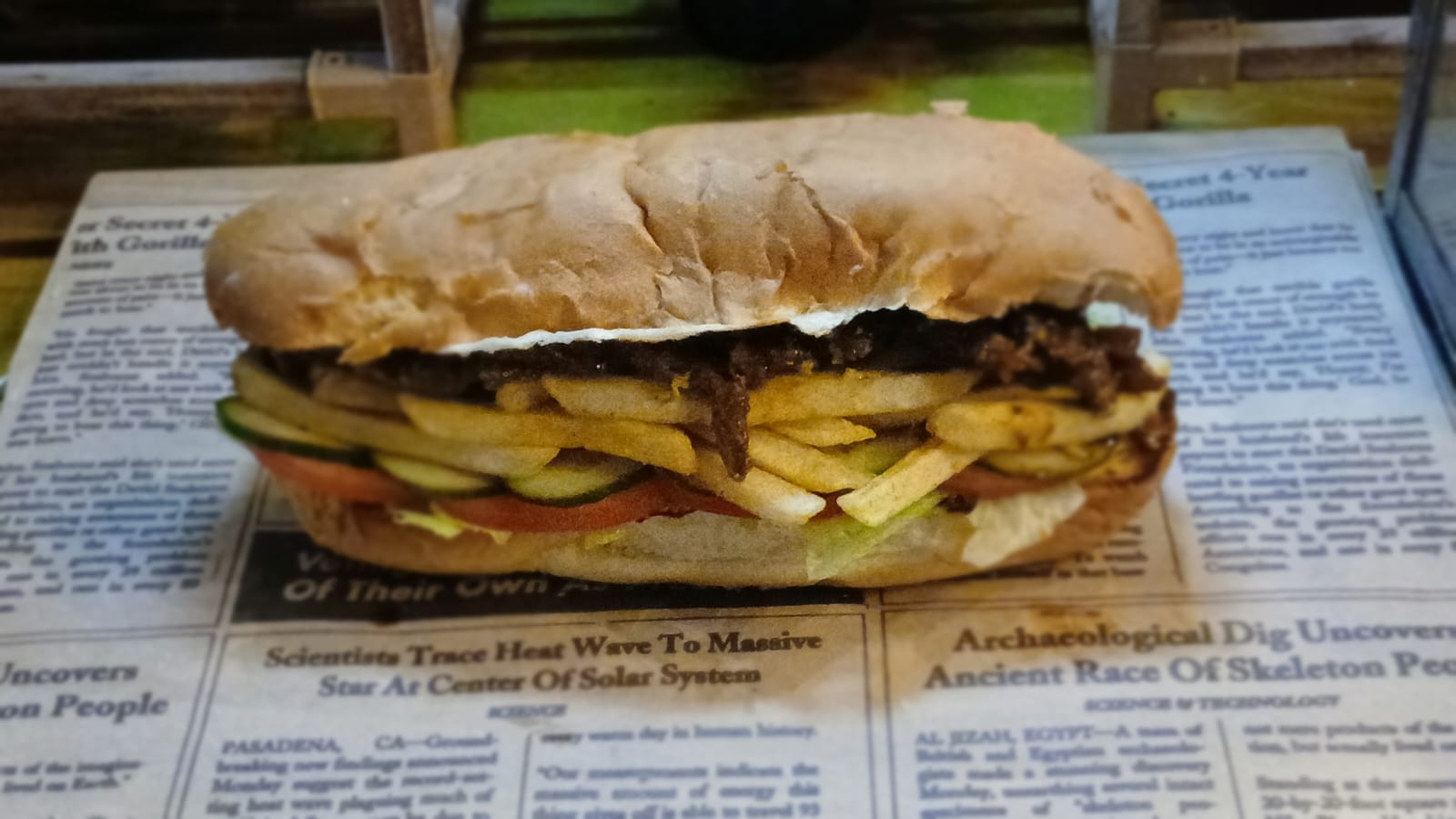 A Gatsby roll packed with sliced steak, chips, tomato and cucumber