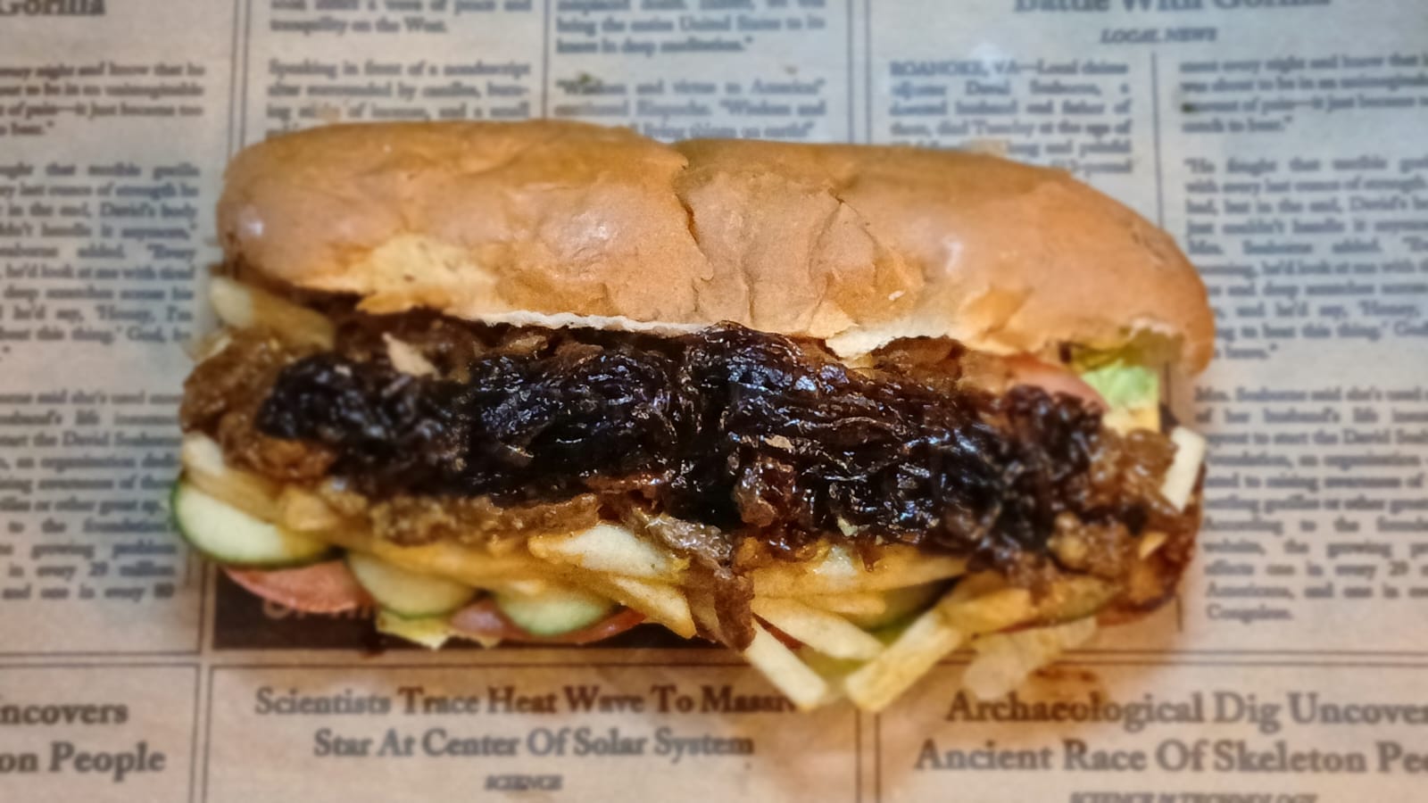 Overhead view of a Gatsby loaded with steak, relish and chips